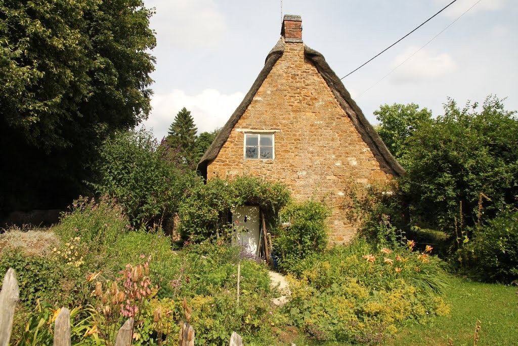 A traditional old cottage with its pretty cottage garden at Alkerton by Roger Sweet